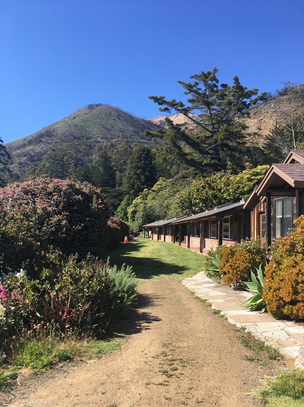 View of a one-story motel-style building with private cabins at Esalen.
